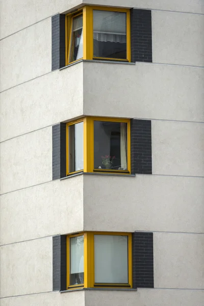 Yellow wooden windows in multi family house