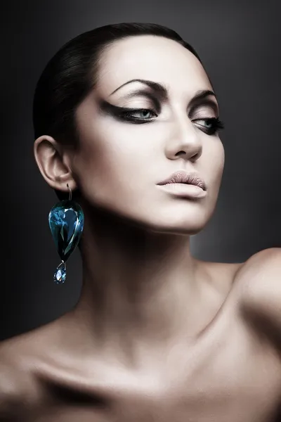 Portrait of brunette woman with diamond earring