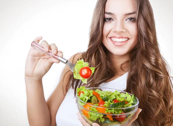 Happy healthy woman with salad on fork