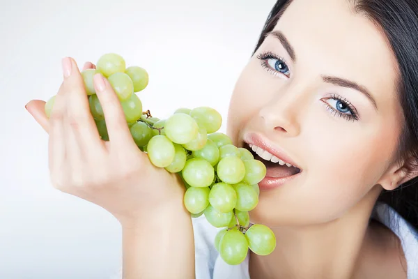 Sexy woman eating grape