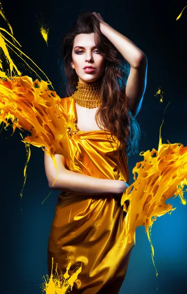 Sensual sexy woman in yellow dress and yellow splash