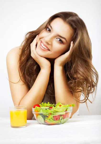 Young cute woman with juice and salad