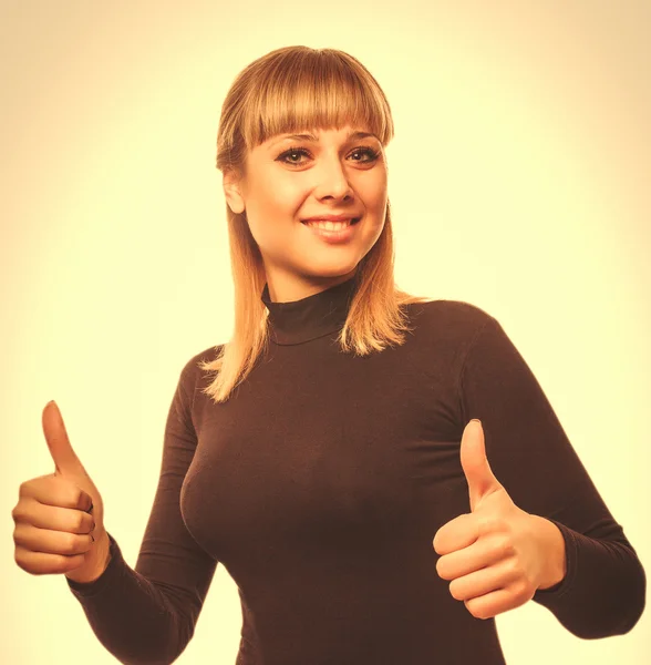 Happy young woman girl a shows positive studio sign thumbs yes,