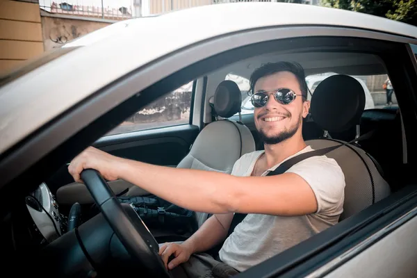 Stylish man driving car