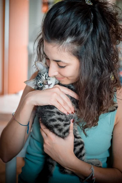 Woman hugging cat