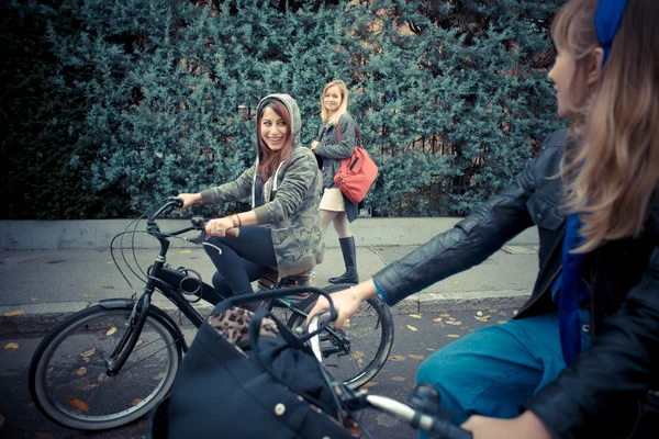 Three friends woman on bike — Stock Photo #35426797