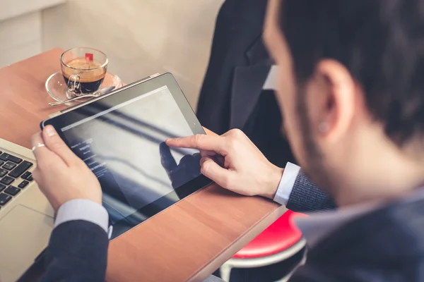 Multitasking man using tablet, laptop and cellhpone