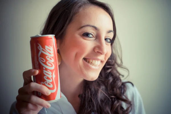 Beautiful woman drinking coca cola can 33 cl