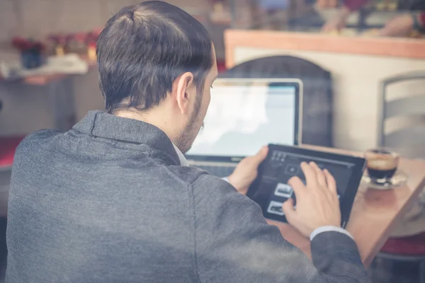 Multitasking man using tablet, laptop and cellhpone