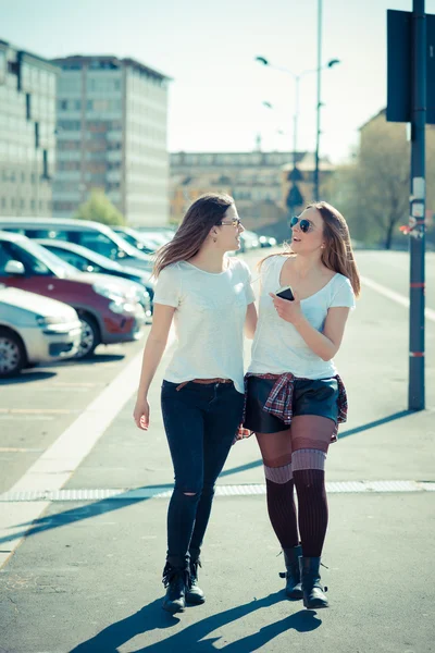 Two beautiful young women walking
