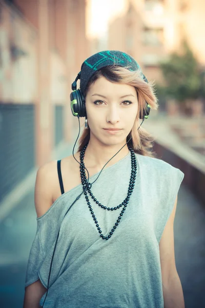 Young beautiful model woman listening music