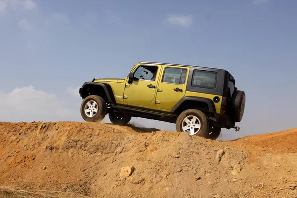 Green Jeep Wrangler Unlimited on 4x4 Course