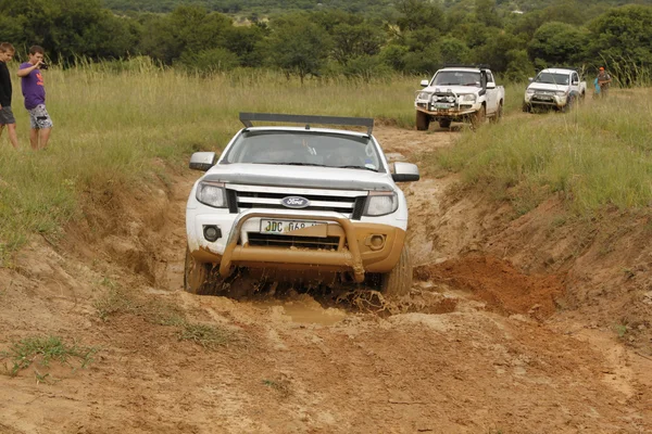 White Ford Ranger XLS with Silver Canopy crossing mud obstacle