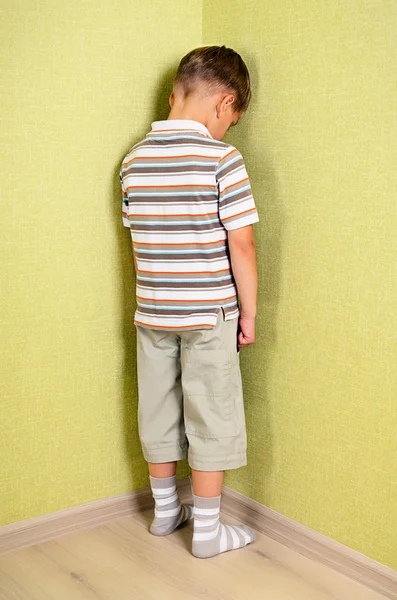 Little child boy wall corner punishment standing