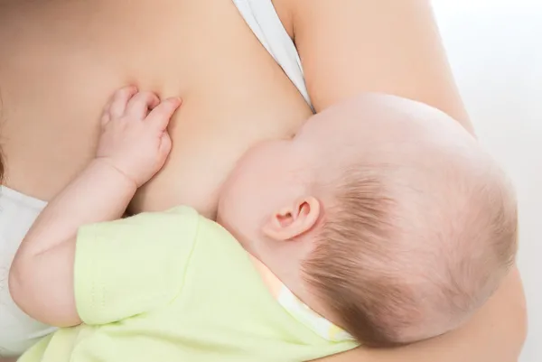 Breast feeding infant child baby with milk