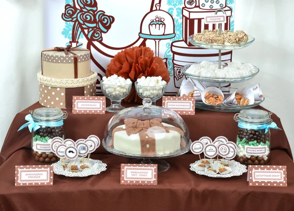 Fancy set table with sweets candies, cake, marshmallows, zephyr,