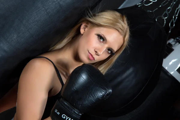 Sport Boxing Woman in black box gloves hit punching ball