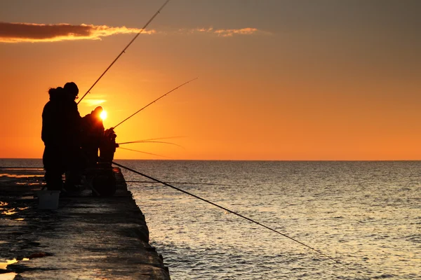 Fishermen at sunrise on the sea