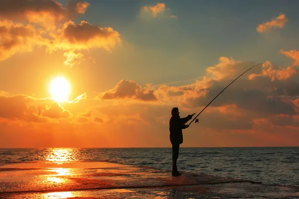 Fisherman on the sea pier