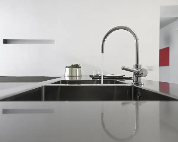 Detail of steel faucet in a modern kitchen
