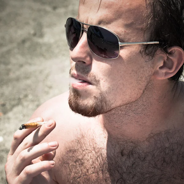 Man smoking hashish joint