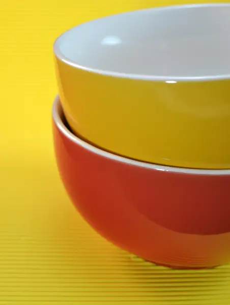 Yellow and red bowl on yellow background