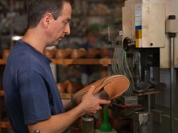 Adult man working in a shoe factory