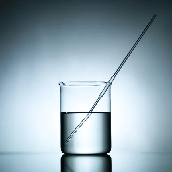 Beaker with dropper and transparent liquid substance