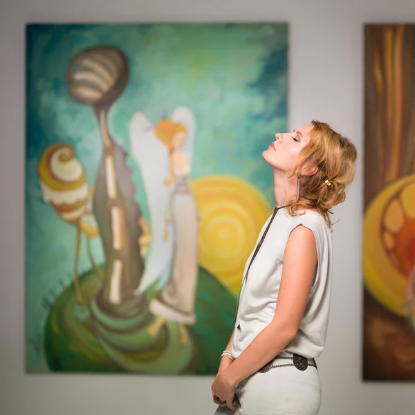 Woman meditating in art gallery