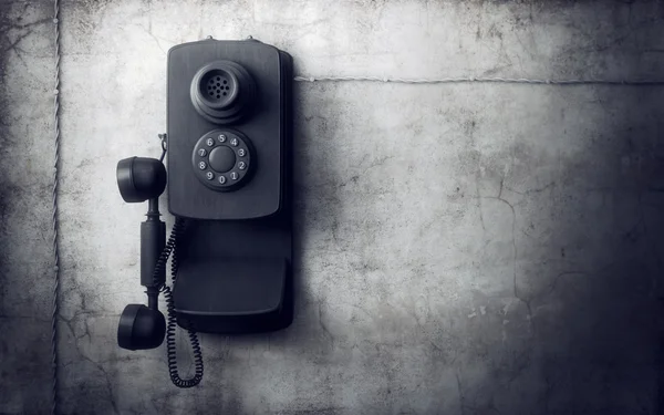 Vintage phone on concrete wall