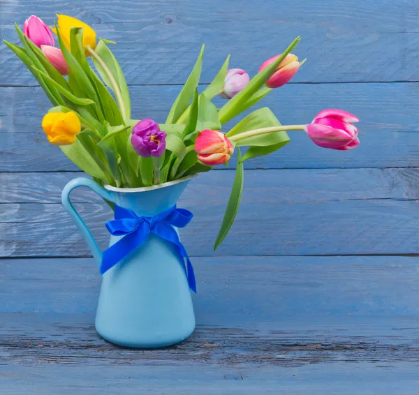 Bouquet of tulips in a blue jug