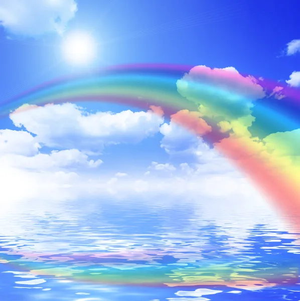 Blue sky background with rainbow and reflection in water