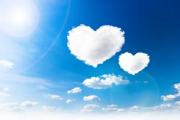 Blue sky with hearts shape clouds. Beauty natural background