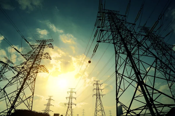 The power transmission towers of sunset sky background