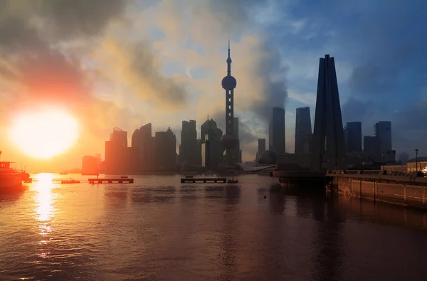 shanghai skyline rising sun viewed from the bund