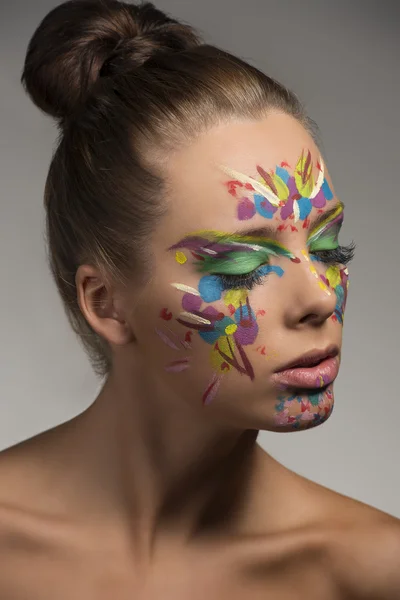 Beauty portrait of girl with creative make-up turned at left
