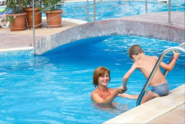 Mother and son in swimming pool.