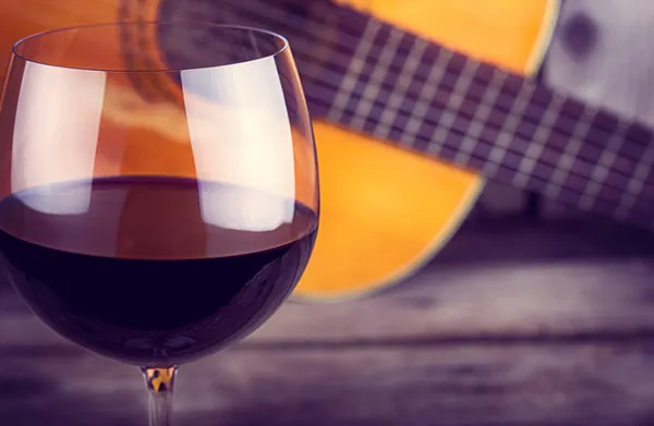 Guitar and Wine on a wooden table
