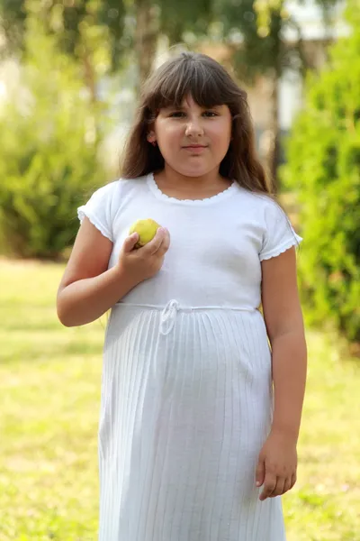 Lovely fat girl eating an apple