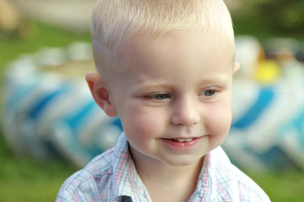 Cute little blond boy in summer clothes