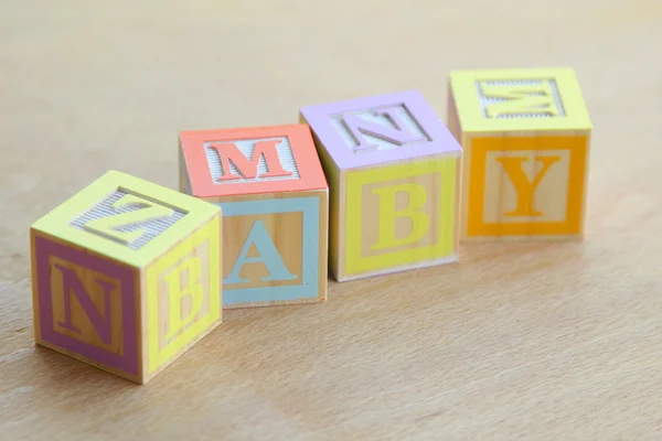 Word baby lined with children's wooden blocks for elementary education alphabet