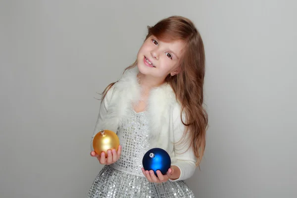 Girl holding Christmas balls