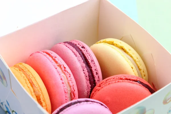 Six Tasty sweet colorful macarons in paper box