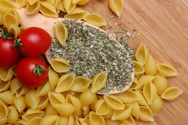 Uncooked pasta and fresh tomatoes