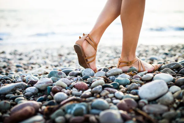 Young woman on the beach enjoying a warm summer evening