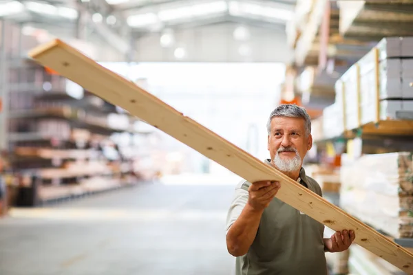 Man buying construction wood in a  DIY store