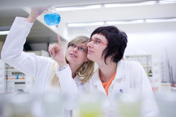 Two female researchers carrying out research in a chemistry lab
