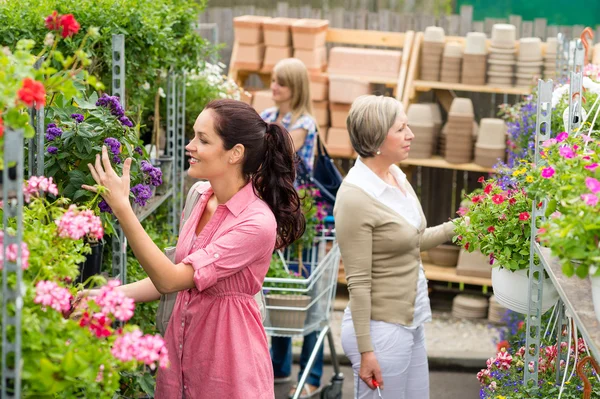 Woman taking potted plant at garden center