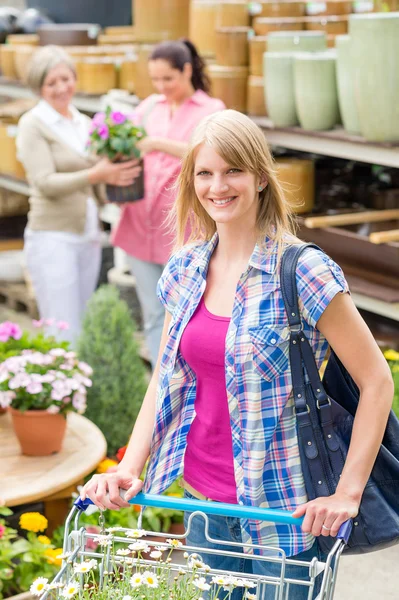 Woman with shopping cart in garden shop