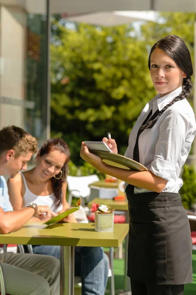 Waitress waiting for clients to decide order